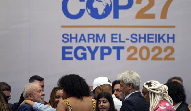 Brazilian President-elect Luiz Inacio Lula da Silva, bottom left, leaves after speaking at a meeting with youth activists at the COP27 U.N. Climate Summit, Thursday, Nov. 17, 2022, in Sharm el-Sheikh, Egypt. (AP Photo/Peter Dejong)