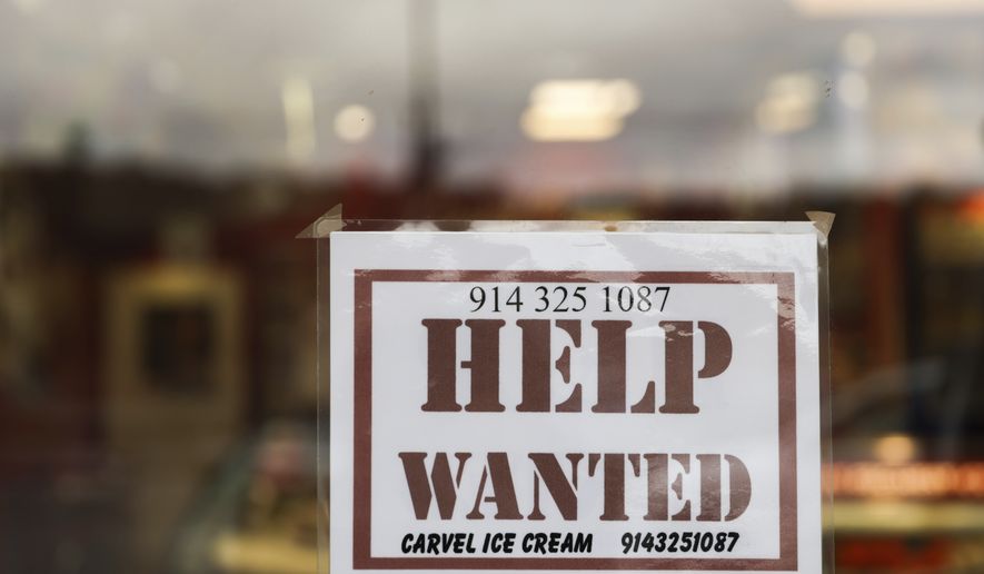A help wanted sign is displayed in a storefront, Tuesday, Nov. 1, 2022, in Bedford, N.Y.  The U.S. job market remains healthy, Thursday, Nov. 17,  as fewer Americans applied for unemployment benefits last week, despite the Federal Reserve’s rapid interest rate hikes this year intended to bring down inflation and tighten the labor market.  (AP Photo/Julia Nikhinson, File)