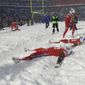 Buffalo Bills players make snow angels in the snow after defeating the Indianapolis Colts after an NFL football game, on Sunday, Dec. 10, 2017, in Orchard Park, N.Y. The NFL is monitoring the weather and has contingency plans in place in the event a lake-effect snowstorm hitting the Buffalo disrupts the Bills ability to host the Cleveland Browns on Sunday, Nov. 20, 2022. (AP Photo/Adrian Kraus, File) **FILE**
