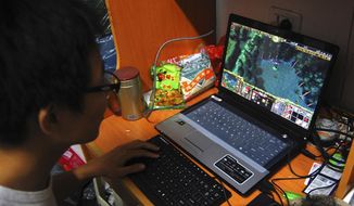 A college student plays the online game World of Warcraft in his dormitory room in southwest China&#39;s Chongqing city. American game developer Blizzard Entertainment said Thursday, Nov. 17, 2022, that it will suspend most of its game services in mainland China after current licensing agreements with Chinese games company NetEase end, sending NetEase’s shares tumbling. (AP Photo, File)