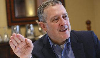 In this Nov. 19, 2019, photo James Bullard, president of the St. Louis Federal Reserve Bank, gestures during an interview in Richmond, Va. The Federal Reserve may have to raise its benchmark interest rate much higher than many people expect to get inflation under control, Bullard said Thursday, Nov. 17, 2022. (AP Photo/Steve Helber, File)