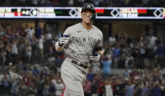 New York Yankees&#39; Aaron Judge gestures as he runs the bases after hitting a solo home run, his 62nd of the season, during the first inning in the second baseball game of a doubleheader against the Texas Rangers in Arlington, Texas, Tuesday, Oct. 4, 2022. With the home run, Judge set the AL record for home runs in a season, passing Roger Maris. Judge won the American League MVP Award on Thursday, Nov. 17, 2022, in voting by a Baseball Writers&#39; Association of America panel. (AP Photo/LM Otero, File) **FILE**
