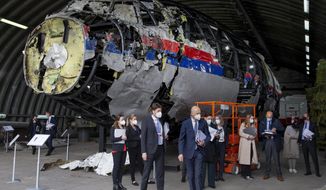 Judges and lawyers view the reconstructed wreckage of Malaysia Airlines Flight MH17, at the Gilze-Rijen military Airbase, southern Netherlands, on May 26, 2021. (AP Photo/Peter Dejong, Pool)