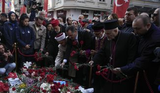 Representatives of the Turkish communities put flowers over a memorial placed on the spot of Sunday&#39;s explosion on Istanbul&#39;s popular pedestrian Istiklal Avenue in Istanbul, Turkey, Wednesday, Nov. 16, 2022.Turkish police said Monday they have detained a Syrian woman with suspected links to Kurdish militants and that she confessed planting a bomb that exploded on a bustling pedestrian avenue in Istanbul, killing six people and wounding several dozen others. (AP Photo/Khalil Hamra)