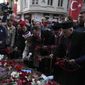 Representatives of the Turkish communities put flowers over a memorial placed on the spot of Sunday&#x27;s explosion on Istanbul&#x27;s popular pedestrian Istiklal Avenue in Istanbul, Turkey, Wednesday, Nov. 16, 2022.Turkish police said Monday they have detained a Syrian woman with suspected links to Kurdish militants and that she confessed planting a bomb that exploded on a bustling pedestrian avenue in Istanbul, killing six people and wounding several dozen others. (AP Photo/Khalil Hamra)