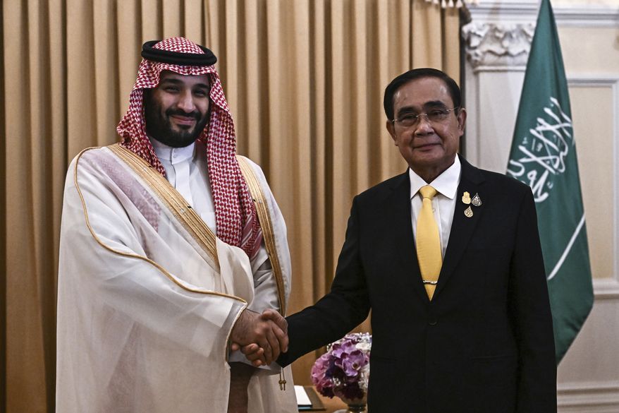 Saudi Crown Prince Mohammed bin Salman shakes hands with Thailand&#x27;s Prime Minister Prayut Chan-o-cha at Goverment House in Bangkok, Friday, Nov. 18, 2022, during the Asia-Pacific Economic Cooperation (APEC) summit. (Lillian Suwanrumpha/Pool Photo via AP)