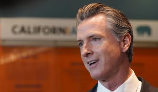 California Gov. Gavin Newsom talks to reporters after voting in Sacramento, Calif., Tuesday, Nov. 8, 2022. Newsom has agreed to release $1 billion in state homelessness funding he testily put on pause earlier this month. But his office says he will do so only if local governments agree to step up the aggressiveness of their plans going forward to reduce homelessness. (AP Photo/Rich Pedroncelli,File)