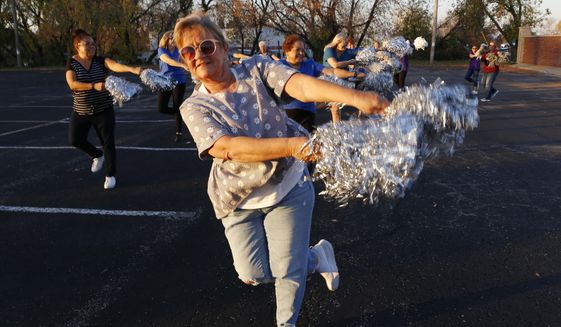 Pam Junion, 65, and other members of the Milwaukee Dancing Grannies practice in a parking lot in Milwaukee on Wednesday, Nov. 2, 2022. Junion is one of a few women who answered a call for new members as the group attempted to rebuild in the face of tragedy. Three Dancing Grannies and one group member’s husband were among those killed at a Christmas parade in Waukesha, Wisconsin, when the driver of an SUV struck them on the parade route. Dozens more, including some Grannies, were injured. (AP Photo/Martha Irvine)