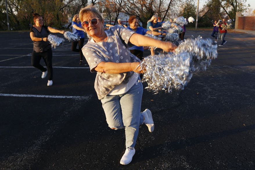 Pam Junion, 65, and other members of the Milwaukee Dancing Grannies practice in a parking lot in Milwaukee on Wednesday, Nov. 2, 2022. Junion is one of a few women who answered a call for new members as the group attempted to rebuild in the face of tragedy. Three Dancing Grannies and one group member’s husband were among those killed at a Christmas parade in Waukesha, Wisconsin, when the driver of an SUV struck them on the parade route. Dozens more, including some Grannies, were injured. (AP Photo/Martha Irvine)