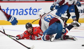 Colorado Avalanche left wing Artturi Lehkonen (62) on top of Washington Capitals center Marcus Johansson (90) during the 2nd period in an NHL game at Capital One Arena in Washington D.C., November 19, 2022. (Photo by Billy Sabatini)