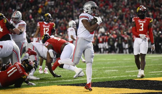 Ohio State running back Dallan Hayden, center, scores a touchdown past Maryland defensive back Deonte Banks (3) and others during the second half of an NCAA college football game, Saturday, Nov. 19, 2022, in College Park, Md. Ohio State won 43-30. (AP Photo/Nick Wass)