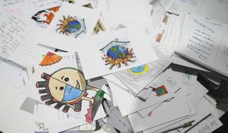 Letters and drawings left behind are gathered at the Youth Pavilion at the COP27 U.N. Climate Summit, Saturday, Nov. 19, 2022, in Sharm el-Sheikh, Egypt. (AP Photo/Peter Dejong)