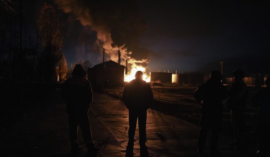 A plume of smoke rises during a fire caused by a Russian airstrike in Kherson, southern Ukraine, Saturday, Nov. 19, 2022. (AP Photo/Roman Hrytsyna)