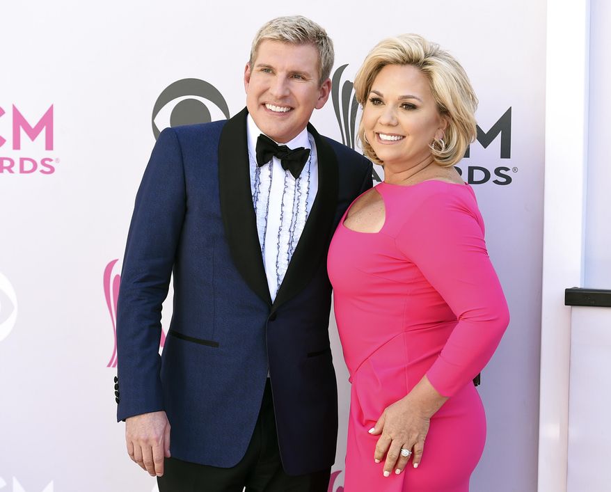 Todd Chrisley, left, and his wife, Julie Chrisley, pose for photos at the 52nd annual Academy of Country Music Awards on April 2, 2017, in Las Vegas. Todd and Julie Chrisley were driven by greed as they engaged in an extensive bank fraud scheme and then hid their wealth from tax authorities while flaunting their lavish lifestyle, federal prosecutors said, arguing the reality television stars should receive lengthy prison sentences. They were found guilty on federal charges in June and are set to be sentenced by U.S. District Judge Eleanor Ross in a hearing that begins Monday, Nov. 21. (Photo by Jordan Strauss/Invision/AP, File)
