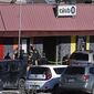 Colorado Springs police, the FBI and others investigate the scene of a shooting at Club Q on Sunday, Nov. 20, 2022 in Colorado Springs, Colo. An attacker opened fire in a gay nightclub late Saturday night. (Helen H. Richardson/The Denver Post via AP)