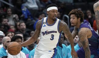 Washington Wizards guard Bradley Beal (3) moves past Charlotte Hornets guard Kelly Oubre Jr., right, during the first half of an NBA basketball game in Washington, Sunday, Nov. 20, 2022. (AP Photo/Susan Walsh)