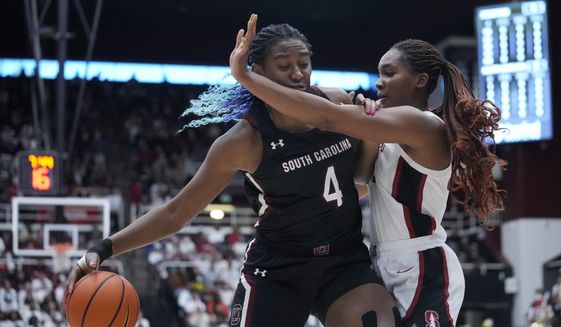 South Carolina forward Aliyah Boston (4) drives to the basket while defended by Stanford forward Kiki Iriafen, right, during the first half of an NCAA college basketball game in Stanford, Calif., Sunday, Nov. 20, 2022. (AP Photo/Godofredo A. Vásquez)