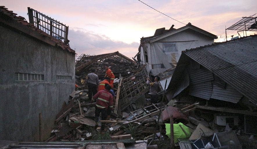 Rescuers search for survivors at the ruins of houses damaged by an earthquake in Cianjur, West Java, Indonesia, Monday, Nov. 21, 2022. The strong, shallow earthquake toppled buildings and collapsed walls on Indonesia&#39;s densely populated main island of Java on Monday, killing a number of people and injuring hundreds as people rushed into the streets, some covered in blood and white debris. (AP Photo/Rangga Firmansyah)