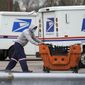 A United States Postal Service employee works outside a post office in Wheeling, Ill., Dec. 3, 2021. (AP Photo/Nam Y. Huh) **FILE**