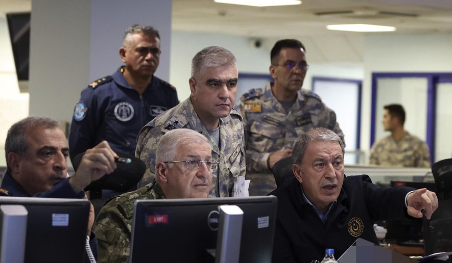 In this photo released by Turkey&#39;s defense ministry, Defense Minister Hulusi Akar, right, and top army commanders work at the Air Force command center, in Ankara, Turkey, early Sunday, Nov. 20, 2022. Turkey launched airstrikes over northern regions of Syria and Iraq, the Turkish Defense Ministry said Sunday, targeting Kurdish groups that Ankara holds responsible for last week&#39;s bomb attack in Istanbul. (Turkish Defense Ministry via AP)