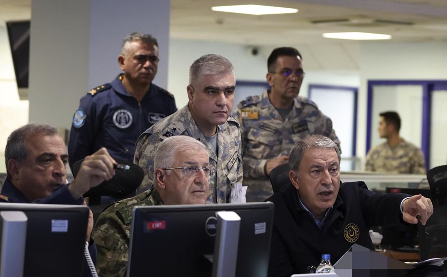 In this photo released by Turkey&#x27;s defense ministry, Defense Minister Hulusi Akar, right, and top army commanders work at the Air Force command center, in Ankara, Turkey, early Sunday, Nov. 20, 2022. Turkey launched airstrikes over northern regions of Syria and Iraq, the Turkish Defense Ministry said Sunday, targeting Kurdish groups that Ankara holds responsible for last week&#x27;s bomb attack in Istanbul. (Turkish Defense Ministry via AP)