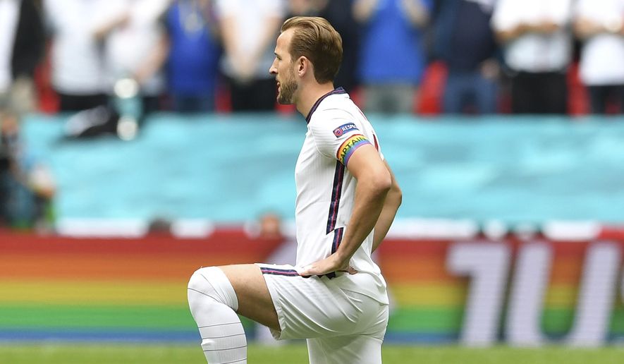 England&#x27;s Harry Kane wears a rainbow armband as he takes the knee prior to the Euro 2020 soccer championship round of 16 match between England and Germany at Wembley Stadium in England. The captains of seven European nations will not wear anti-discrimination armbands in World Cup games after threats from FIFA to show yellow cards to the players. The seven soccer federations say &amp;quot;we can’t put our players in a position where they could face sporting sanctions.”  (Justin Tallis, Pool Photo via AP) **FILE**