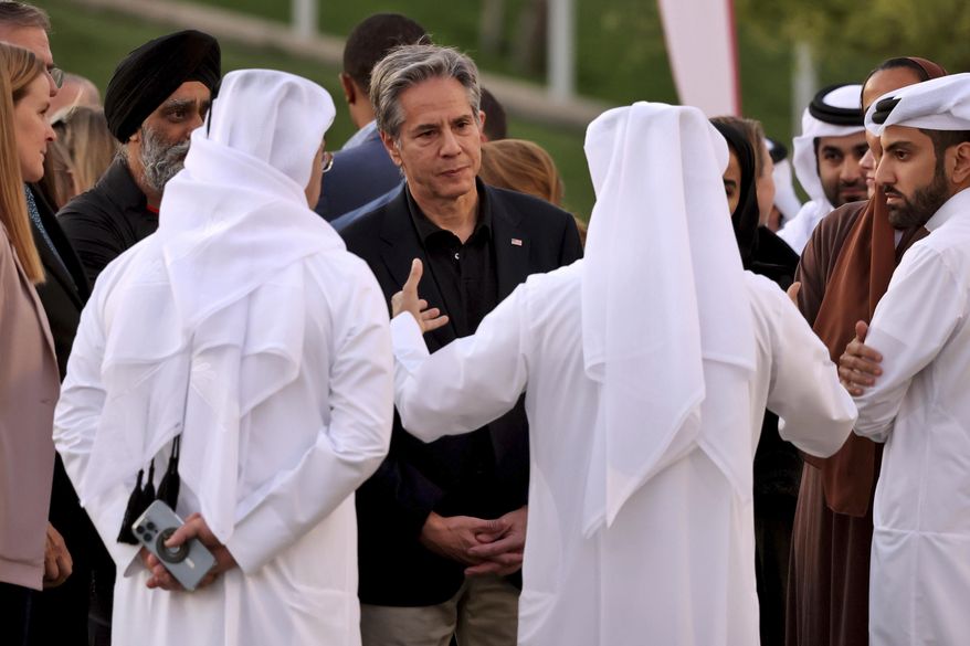 U.S. Secretary of State Anthony Blinken listens to officials during a visit to Oxygen Park at Education City, in Doha Qatar, Monday, Nov. 21, 2022. (Karim Jaafar/Pool via AP)