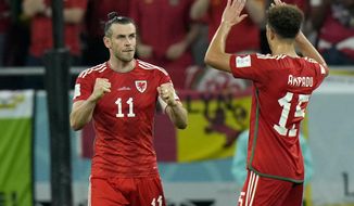 Wales&#39; Gareth Bale celebrates with Ethan Ampadu, right, after scoring his side&#39;s first goal from the penalty spot during the World Cup, group B soccer match between the United States and Wales, at the Ahmad Bin Ali Stadium in Doha, Qatar, Monday, Nov. 21, 2022. (AP Photo/Francisco Seco)
