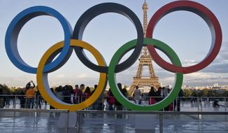 The Olympic rings are set up at Trocadero plaza that overlooks the Eiffel Tower, a day after the official announcement that the 2024 Summer Olympic Games will be in the French capital, in Paris, Thursday, Sept. 14, 2017. The budget for the 2024 Paris Olympics is expected to go up by 10%, in part because of high inflation, organizers said Tuesday, Nov.22, 2022. The organizing committee, known as COJO, had an original budget of around 4 billion euros ($4.1 billion) but will present a revised figure at a board meeting next month that is expected to reach 4.4 billion euros ($4.5 billion). (AP Photo//Michel Euler, File)