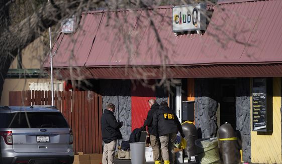 Law enforcement investigators exit Club Q, the site of a weekend mass shooting, on Tuesday, Nov. 22, 2022, in Colorado Springs, Colo.  Anderson Lee Aldrich opened fire at Club Q, in which five people were killed and others suffered gunshot wounds before patrons tackled and beat the suspect into submission.   (AP Photo/David Zalubowski)