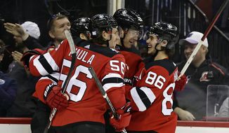New Jersey Devils defenseman Damon Severson (28) celebrates with teammates after scoring a goal against the Edmonton Oilers during the second period of an NHL hockey game Monday, Nov. 21, 2022, in Newark, N.J. The New Jersey Devils cannot sneak up on teams anymore. The once-laughable also-rans have gone from a team that has missed the Stanley Cup playoffs nine of the last 10 years to currently the NHL&#39;s hottest team. (AP Photo/Adam Hunger, File)