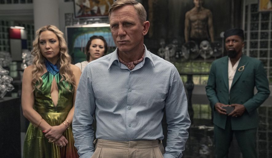 This image released by Netflix shows Kate Hudson, from left, Jessica Henwick, Daniel Craig and Leslie Odom Jr. in a scene from &amp;quot;Glass Onion: A Knives Out Mystery.&amp;quot;  (John Wilson/Netflix via AP)