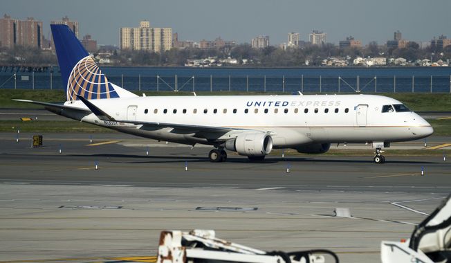 A United Airlines plane at LaGuardia Airport&#x27;s Terminal B, Tuesday, Nov. 22, 2022, in New York.  (AP Photo/Julia Nikhinson)