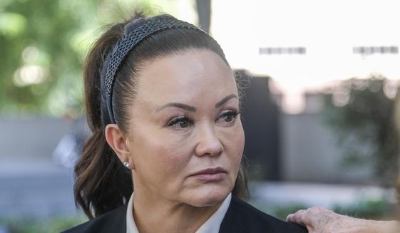 Alana Gee, the widow of a former University of Southern California football player suing the NCAA for failing to protect her husband from repetitive head trauma, leaves the Stanley Mosk civil courthouse of Los Angeles Superior Court on Oct. 21, 2022. Attorneys asked a jury Monday, Nov. 21, 2022, to award $55 million to Gee in the landmark case. (AP Photo/Ringo H.W. Chiu, File) **FILE**