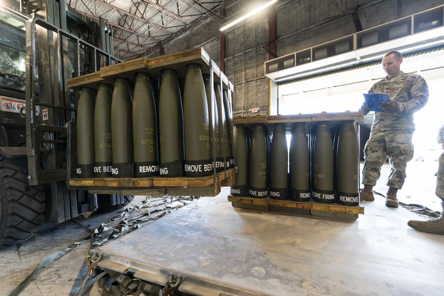 U.S. Air Force Staff Sgt. Cody Brown, right, with the 436th Aerial Port Squadron, checks pallets of 155 mm shells ultimately bound for Ukraine, April 29, 2022, at Dover Air Force Base, Del. The U.S. is sending another $400 million to Ukraine, pushing needed ammunition and generators to Ukraine from its own stockpiles, which will allow the aid to get to Ukraine faster than if the Pentagon procured the weapons from industry., getting needed heat and additional air defenses to Kyiv as winter sets in.  (AP Photo/Alex Brandon, File)