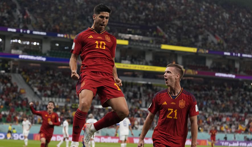 Spain&#39;s Marco Asensio, left, celebrates with Dani Olmo after scoring his side&#39;s second goal during the World Cup group E soccer match between Spain and Costa Rica, at the Al Thumama Stadium in Doha, Qatar, Wednesday, Nov. 23, 2022. (AP Photo/Alessandra Tarantino)
