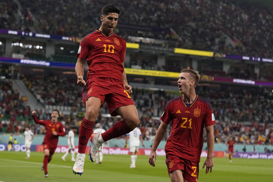 Spain&#x27;s Marco Asensio, left, celebrates with Dani Olmo after scoring his side&#x27;s second goal during the World Cup group E soccer match between Spain and Costa Rica, at the Al Thumama Stadium in Doha, Qatar, Wednesday, Nov. 23, 2022. (AP Photo/Alessandra Tarantino)