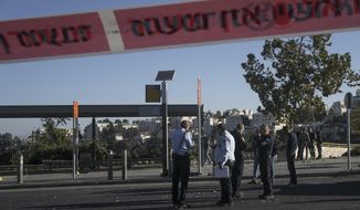 Israeli police inspect the scene of an explosion at a bus stop in Jerusalem, Wednesday, Nov. 23, 2022. Two blasts went off near bus stops in Jerusalem on Wednesday, injuring several people in what police said were suspected attacks by Palestinians. (AP Photo/Maya Alleruzzo)