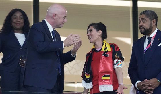 Belgium Foreign Minister Hadja Lahbib, wearing a &amp;quot;One Love&amp;quot; armband, talks with FIFA President Gianni Infantino, left, on the tribune during the World Cup group F soccer match between Belgium and Canada, at the Ahmad Bin Ali Stadium in Doha, Qatar, Wednesday, Nov. 23, 2022. (AP Photo/Natacha Pisarenko)