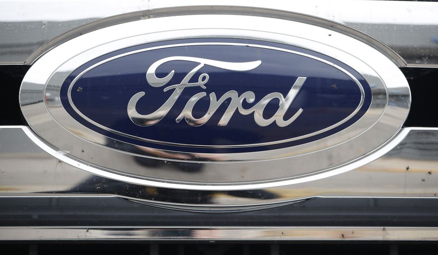 FILE - In this Oct. 20, 2019 file photograph, the company logo shines off the grille of an unsold vehicle at a Ford dealership in Littleton, Colo. Ford is recalling over 634,000 SUVs worldwide, Thursday, Nov. 24, 2022, because a cracked fuel injector can spill fuel or leak vapors onto a hot engine and cause fires. The recall covers Bronco Sport and Escape SUVs from the 2020 through 2023 model years with 1.5-liter, three-cylinder engines.  (AP Photo/David Zalubowski, File)
