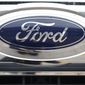 FILE - In this Oct. 20, 2019 file photograph, the company logo shines off the grille of an unsold vehicle at a Ford dealership in Littleton, Colo. Ford is recalling over 634,000 SUVs worldwide, Thursday, Nov. 24, 2022, because a cracked fuel injector can spill fuel or leak vapors onto a hot engine and cause fires. The recall covers Bronco Sport and Escape SUVs from the 2020 through 2023 model years with 1.5-liter, three-cylinder engines.  (AP Photo/David Zalubowski, File)