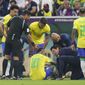 Brazil&#39;s Neymar, bottom, is treated by members of his team during the World Cup group G soccer match between Brazil and Serbia, at the Lusail Stadium in Lusail, Qatar, Thursday, Nov. 24, 2022. (AP Photo/Aijaz Rahi)