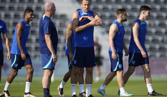 England&#39;s Harry Kane, middle, stands on the field during England&#39;s official training on the eve of the group B World Cup soccer match between England and the United States, at Al Wakrah Sports Complex, in Al Wakrah, Qatar, Thursday, Nov. 24, 2022. (AP Photo/Abbie Parr)