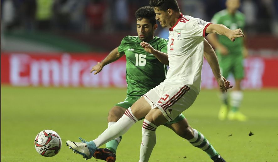 Voria Ghafouri, then an Iranian national soccer team player, right, fights for the ball with Iraqi midfielder Hussein Ali, during the AFC Asian Cup soccer match at the Al Maktoum Stadium in Dubai, United Arab Emirates, Jan. 16, 2019. The semiofficial Fars and Tasnim news agencies reported on Thursday, Nov. 24, 2022, that Iran arrested Ghafouri, a prominent former member of its national soccer team, for insulting the national soccer team, which is currently playing in the World Cup, and criticizing the government as authorities grapple with nationwide protests. (AP Photo/Kamran Jebreili, File)