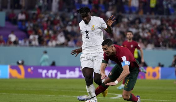 Ghana&#39;s Mohammed Salisu fouls in the penalty box Portugal&#39;s Cristiano Ronaldo during a World Cup group H soccer match at the Stadium 974 in Doha, Qatar, Thursday, Nov. 24, 2022. (AP Photo/Manu Fernandez)