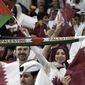 Fans wave the Palestinian flag and cheer prior the World Cup, group A soccer match between Qatar and Ecuador at the Al Bayt Stadium in Al Khor, Sunday, Nov. 20, 2022. (AP Photo/Ariel Schalit)