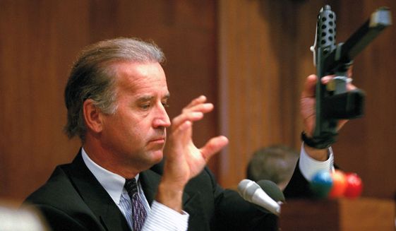 FILE - Sen. Joe Biden, D-Del., chairman of the Senate Judiciary Committee, holds a TEC-9 semi-automatic weapon during a hearing of the committee on Capitol Hill, Aug. 3, 1993, as the committee holds hearings on combating the proliferation of assault weapons. (AP Photo/Barry Thumma, File)