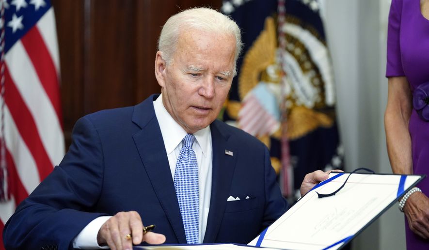 President Joe Biden signs into law S. 2938, the Bipartisan Safer Communities Act gun safety bill, in the Roosevelt Room of the White House in Washington, June 25, 2022. (AP Photo/Pablo Martinez Monsivais, File)