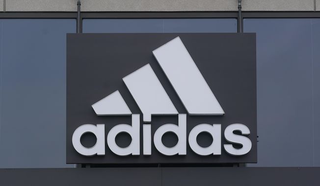 A sign is displayed in front of an Adidas retail store in Paramus, N.J., Oct. 25, 2022. Adidas says it is investigating allegations of inappropriate workplace conduct by the rapper formerly known as Kanye West that ex-employees made in an anonymous letter also accusing the German sportswear brand of looking the other way. (AP Photo/Seth Wenig)