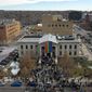 In this aerial image taken with a drone, a rainbow flag is unfurled at City Hall Wednesday, Nov. 23, 2022, in Colorado Springs, Colo. With a growing and diversifying population, the city nestled at the foothills of the Rockies is a patchwork of disparate social and cultural fabrics. But last weekend’s shooting has raised uneasy questions about the lasting legacy of cultural conflicts that caught fire decades ago and gave Colorado Springs a reputation as a cauldron of religion-infused conservatism, where LGBTQ people didn&#39;t fit in with the most vocal community leaders&#39; idea of family values (AP Photo/Brittany Peterson)